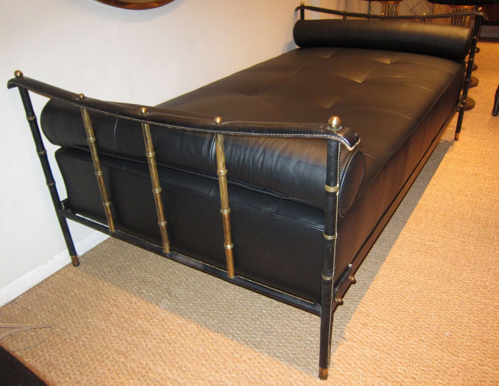 Superb hand stitched black leather and faux bamboo brass day bed by Jacques Adnet. Newly upholstered bolsters and mattress.
