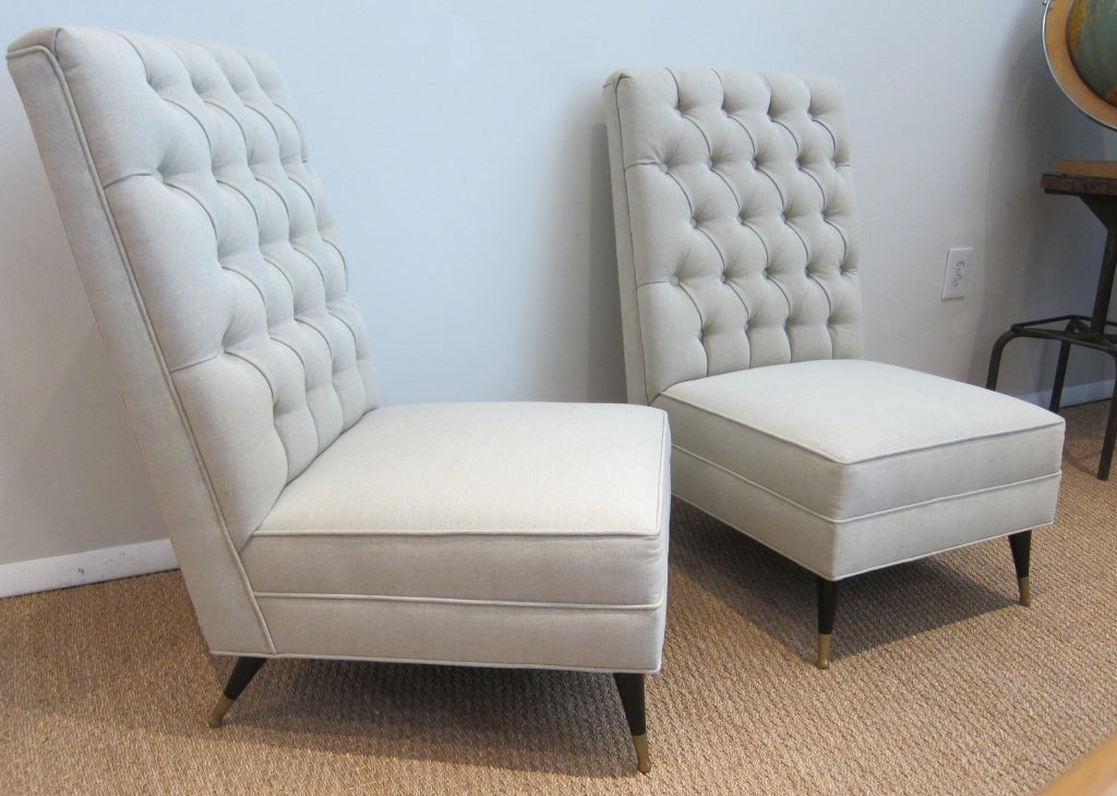 Pair of French 1950's slipper chairs, ebonized wood with brass sabots. Newly upholstere with silk linen.