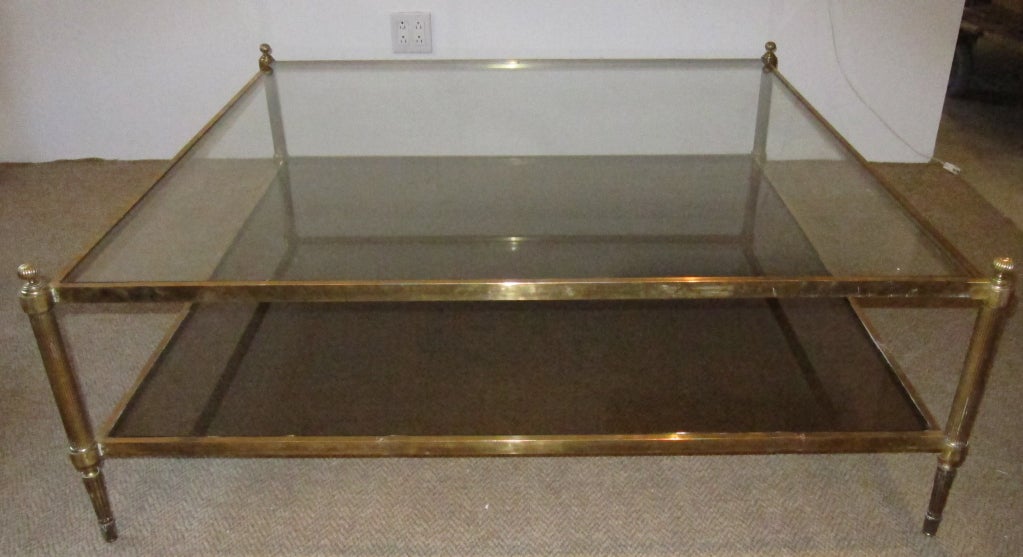 A superb oversized two tiers brass with inset glass coffee table. France circa 1950's.