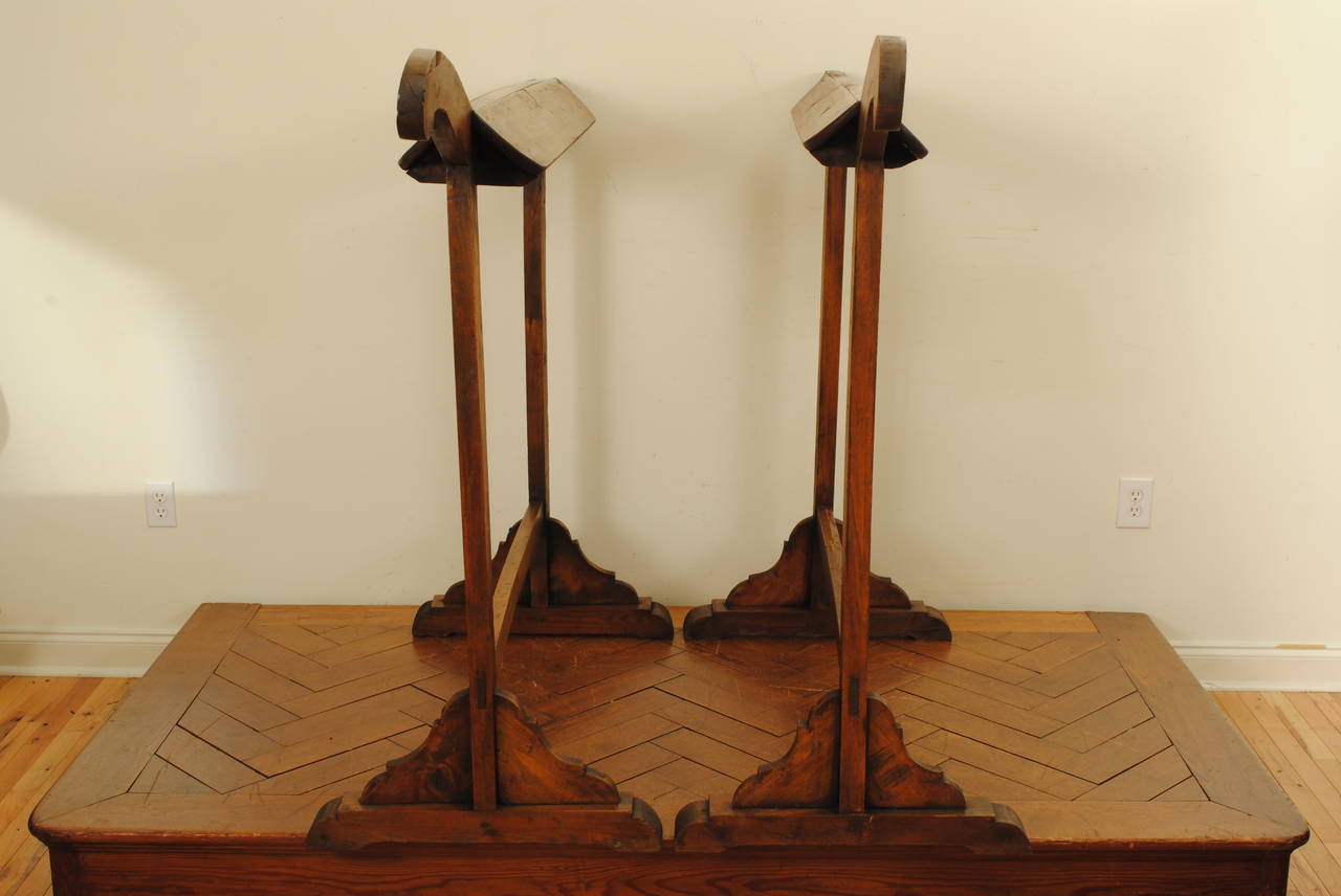 Constructed of poplar and stained a dark walnut color, the angled top section above supports terminating in trestle-form bracket feet connected by a straight stretcher. With a 