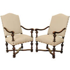 A Pair of Late Louis XIII Period, early 18thc, Walnut and Upholstered Fauteuils