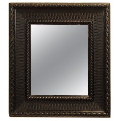 An Early 18th Century Carved and Ebonized Frame, now mounted as a mirror