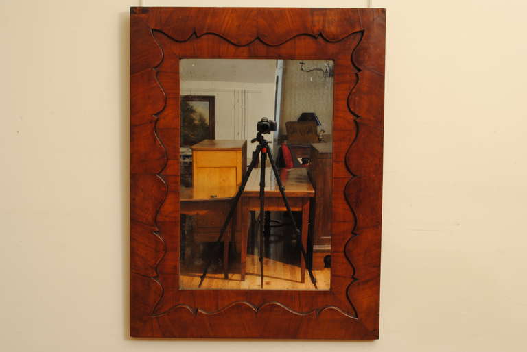 probably late 2nd quarter 19th century the shaped pattern cut into the interior of the frame, retaining old mirrorplate, original backing