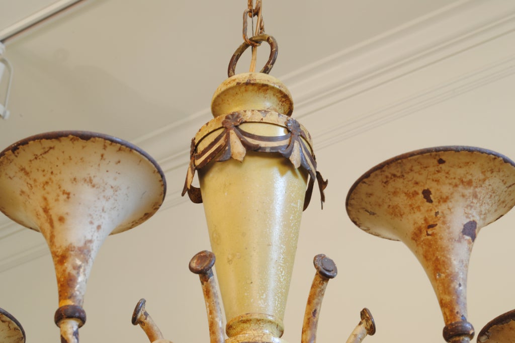 having six uplights shaped like horns with decorative swags circling the body, the arms connected by rope-form metal, also having a downlight.  An additional 32 inches of custom chain and canopy are available