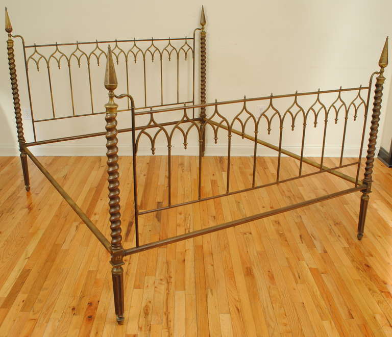 consisting of headboard, footboard, and two later painted steel rails, each corner with a pointed finial, barley twist post, and terminating in an octagonal tapering leg, headboard and footboard comprised of pointed gothic arches, rails rest at 16