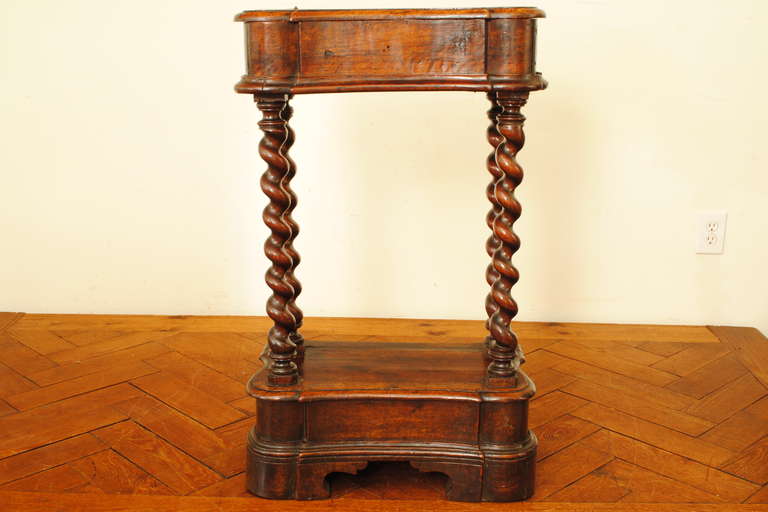 the shaped hinged top above a conforming frieze flanked by spiral carved columns, raised on a shaped molded base ending in bracket feet

Please go to www.robuck.co to see our complete inventory.