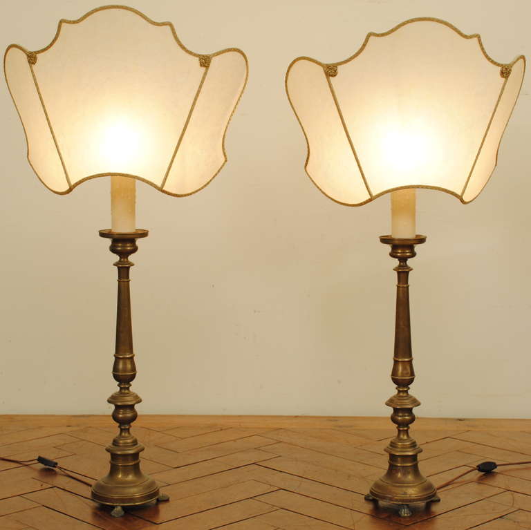 of cast brass with a wooden interior raised on cast paw feet and now mounted as table lamps with later custom half shades, diameter of base measures 7 inches

Please go to www.robuck.co to see our complete inventory.