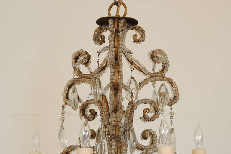 The gilt iron frame trimmed in glass bead chains and having hanging prisms.