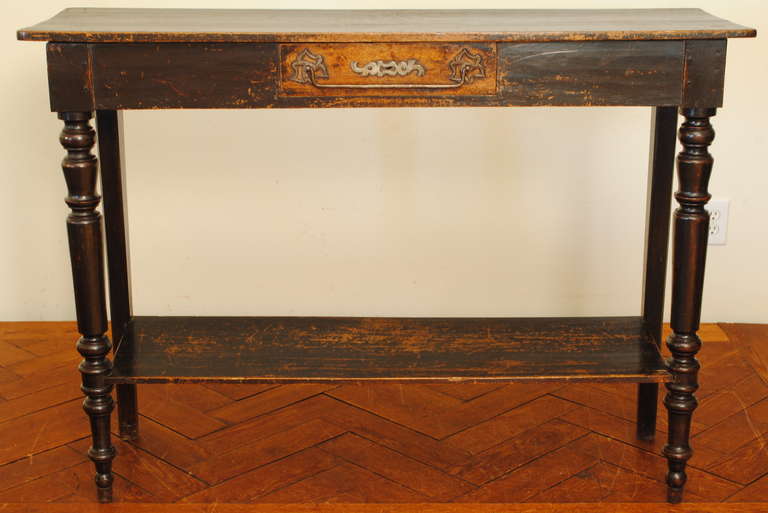 the rectangular top above a conforming case housing one drawer, the rear legs square and tapered, the front legs turned and tapered, joined by a shelf stretcher