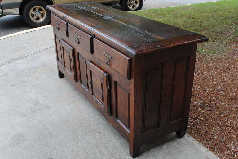 the early kitchen island, the top attached together with iron bands, or rectangular form and housing three deep drawers over two drawers, raised on block feet