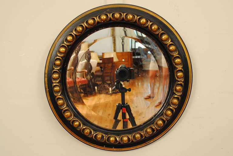 round with beveled mirrorplate, carved giltwood half spheres