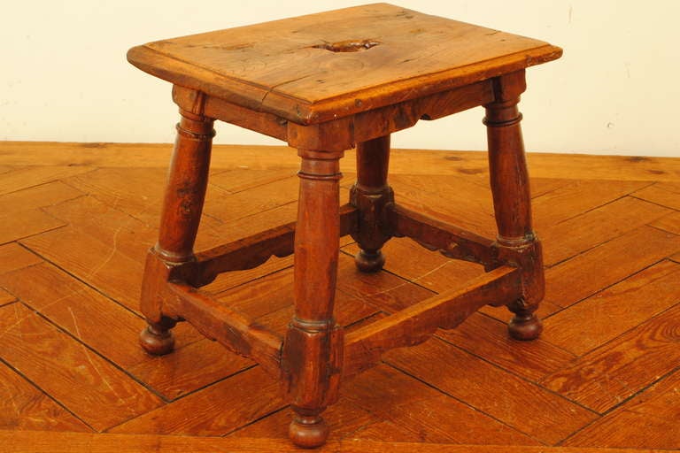 carved walnut milking stool or small table with turned legs and carved stretches, top with opening created around a knot in the wood

Please go to www.robuck.co to see our complete inventory.