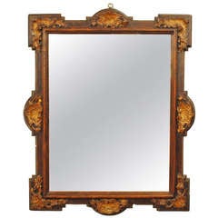 An Elaborately Carved Portuguese Walnut and Giltwood Mirror