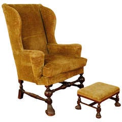 An Italian Walnut and Velvet Upholstered Wingback Chair with Ottoman