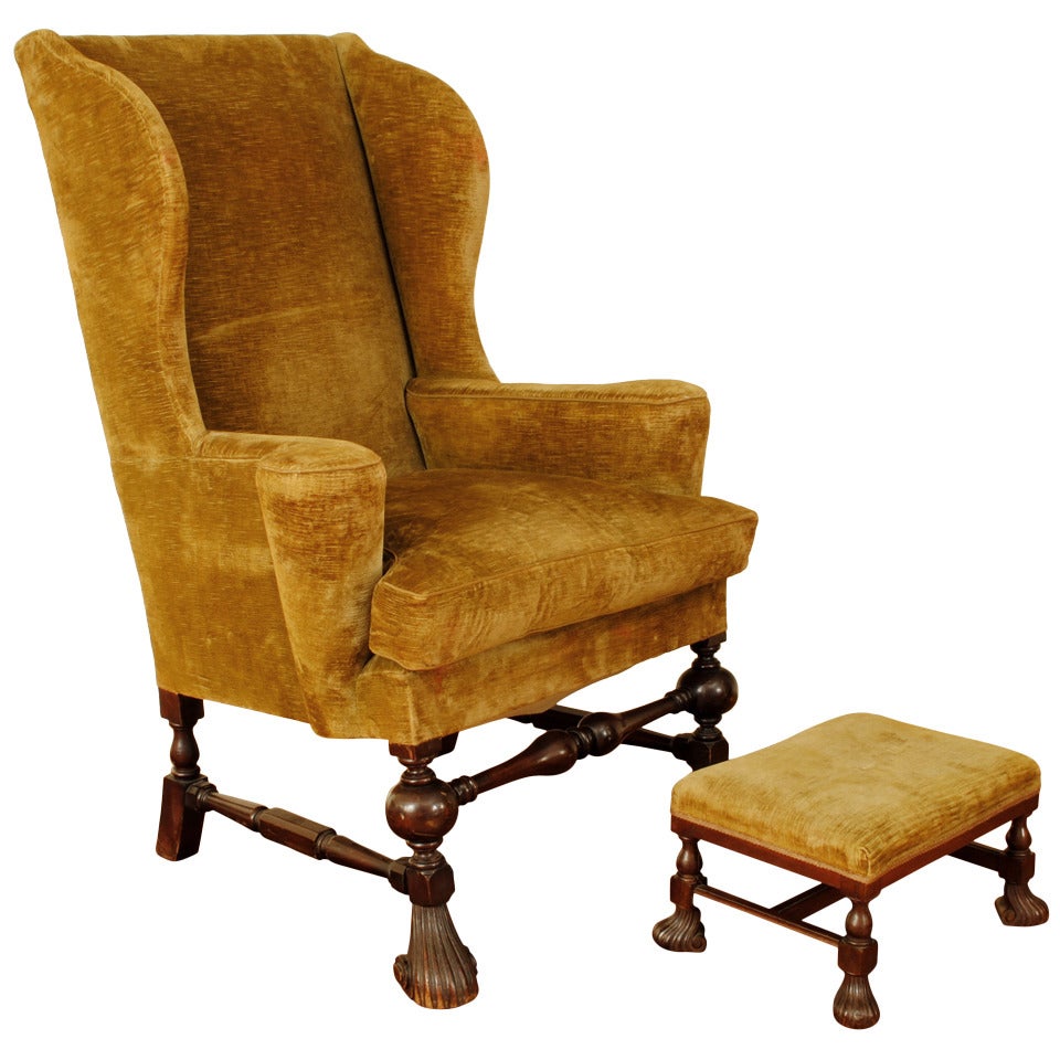 An Italian Walnut and Velvet Upholstered Wingback Chair with Ottoman