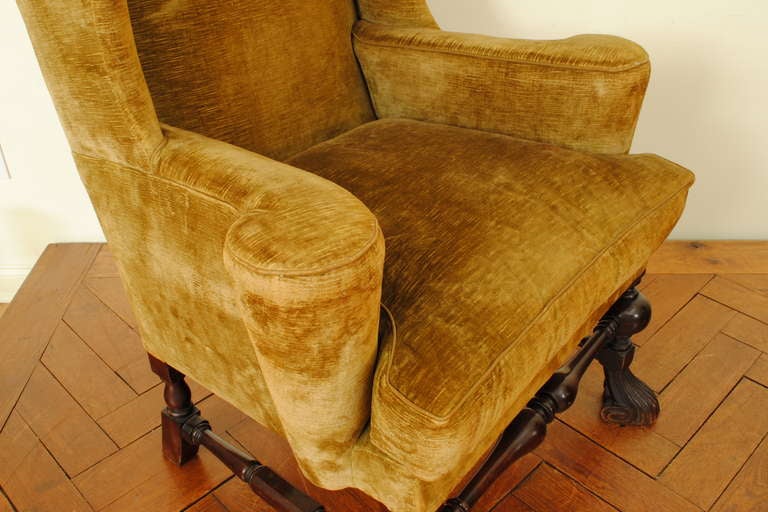 An Italian Walnut and Velvet Upholstered Wingback Chair with Ottoman 2