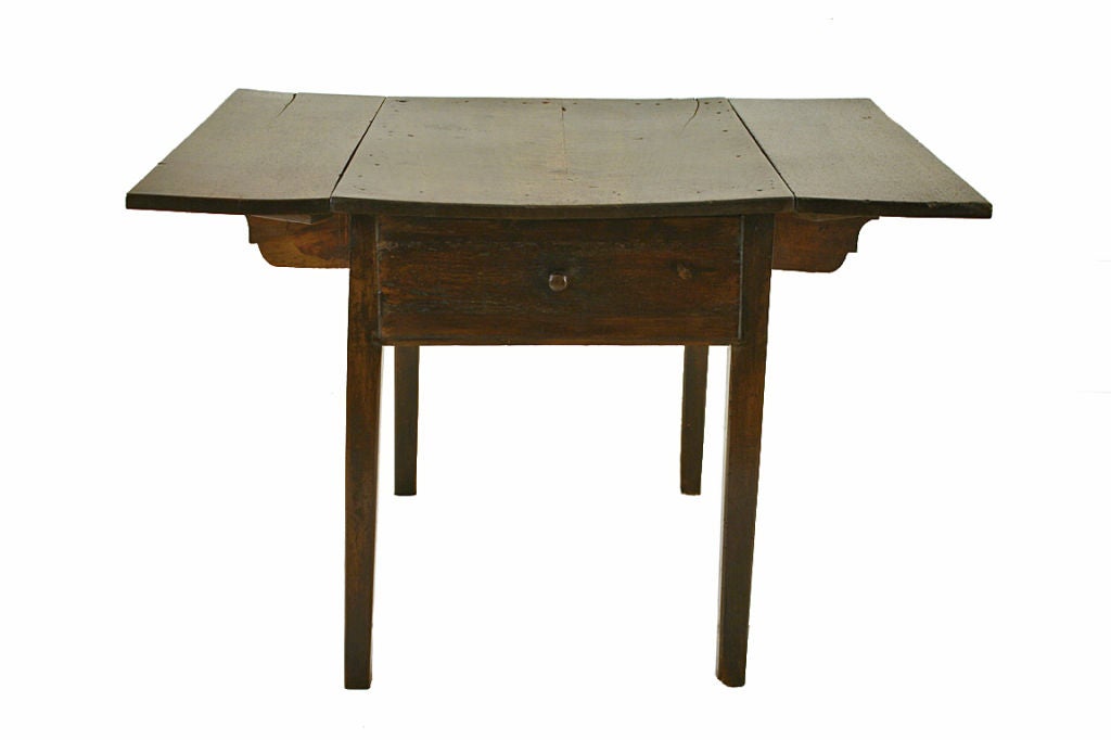 A Spanish LXVI Period Walnut and Pine Drop Leaf Kitchen Table