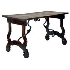 An Italian Baroque Style Walnut and Iron Stretcher Table
