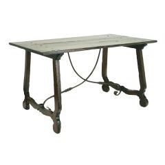 An Italian Baroque Walnut Trestle Table with Iron Stretcher