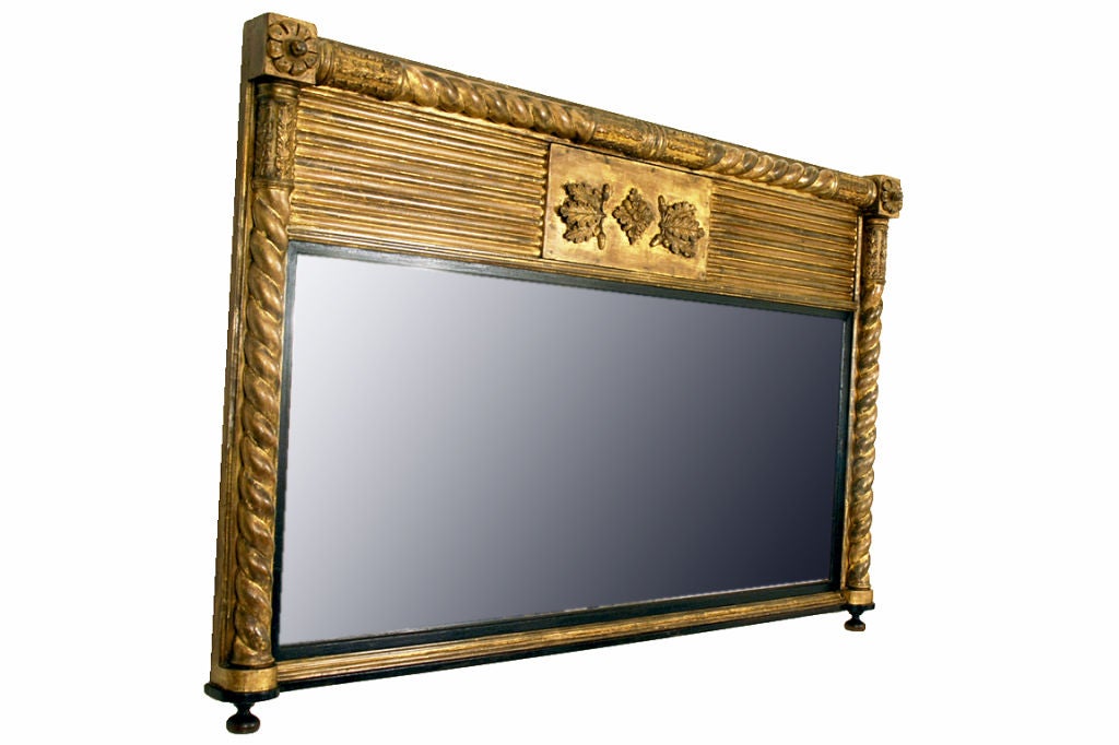 A French Late Empire Giltwood and Ebonized Overmantel Mirror