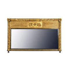 A French Late Empire Giltwood and Ebonized Overmantel Mirror