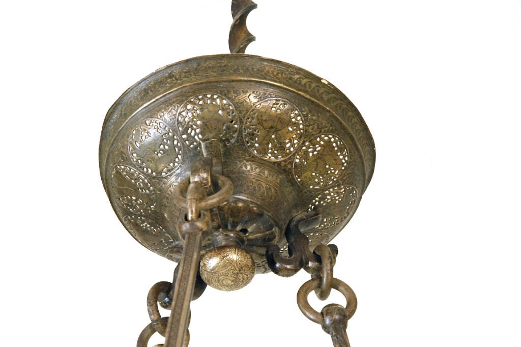patinated brass with finely cast details of various figures and animals, the arms extending from the bowl shaped body, hanging from rods connected by spheres, the canopy with detailed castings as well