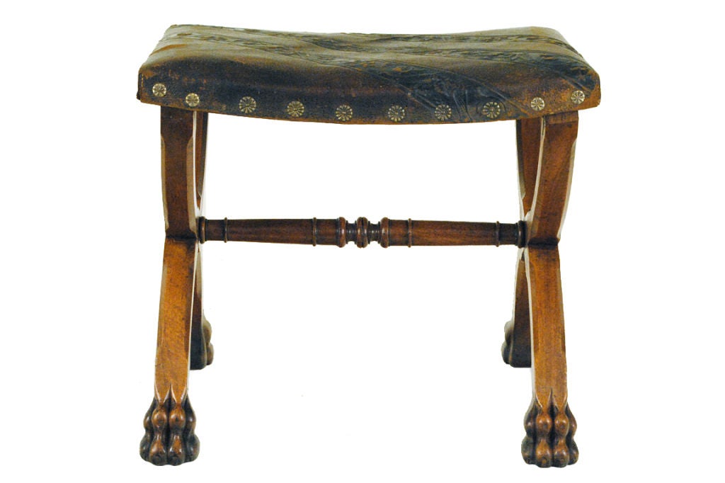 A Spanish Baroque Style Carved Walnut Bench, Tooled Leather Top