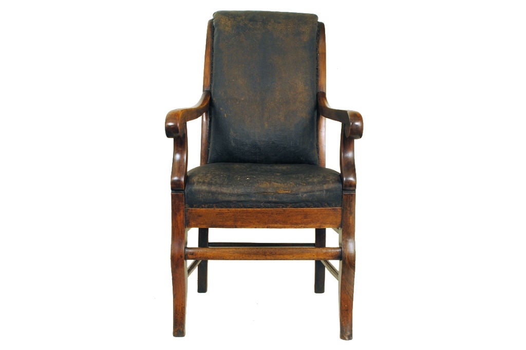 A French Restauration Period Walnut and Leather Fauteuil