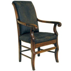 A French Restauration Period Walnut and Leather Fauteuil