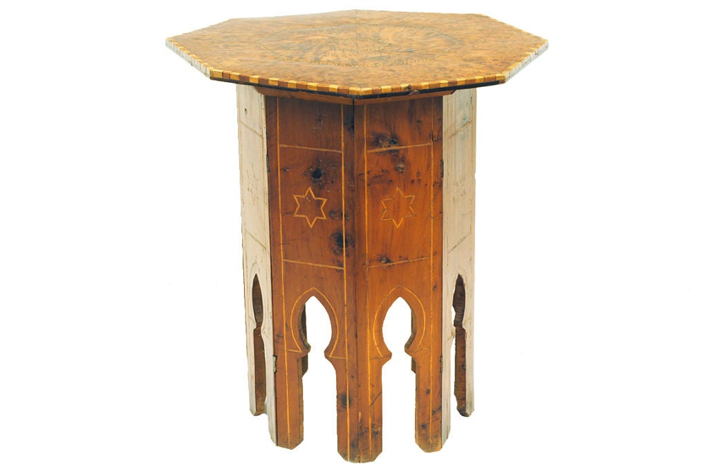 having an octagonal top covered in burl walnut venner and an alternating veneered outside edge, the folding base with Moorish arches and star and band inlays