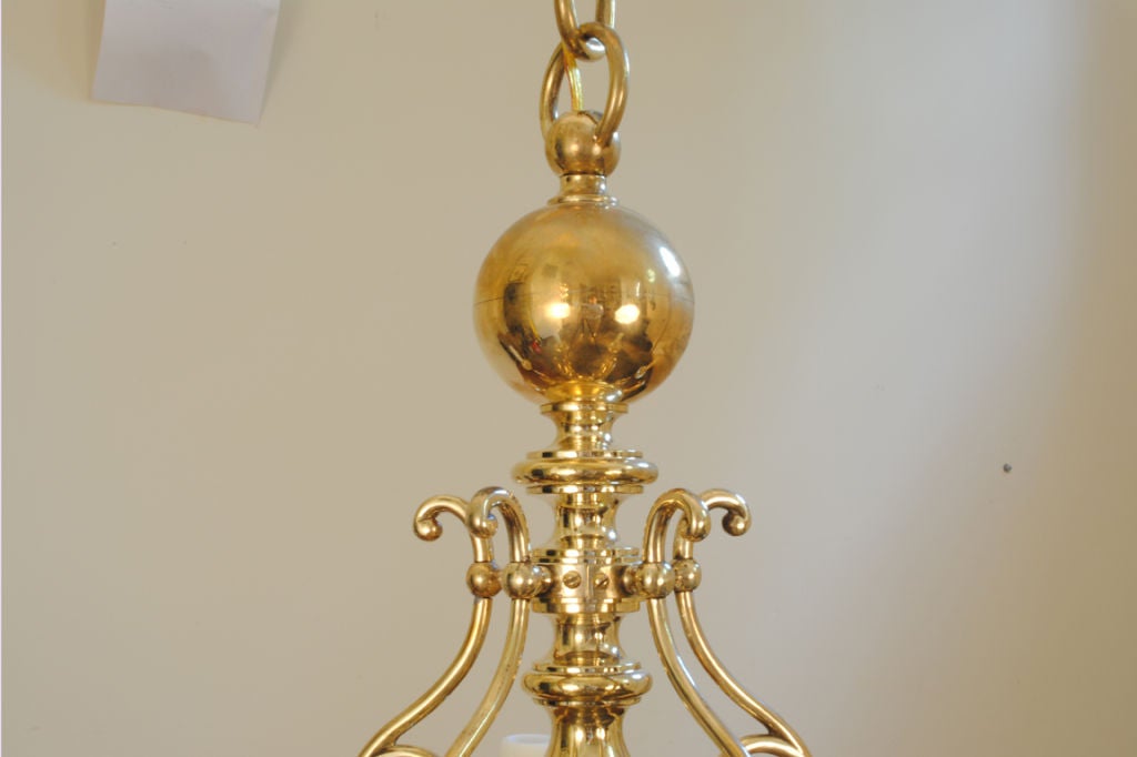 in the Dutch style and having hollowed curving arms attached to a ball-form body, electrified, having ample original large-loop brass chain