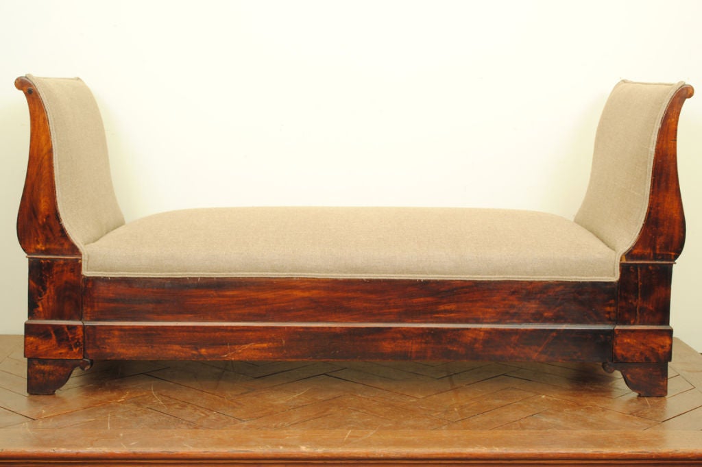 of pegged construction and having outwardly curved upholstered sides above a solid mahogany frame resting on bracket feet, the reverse with an open front