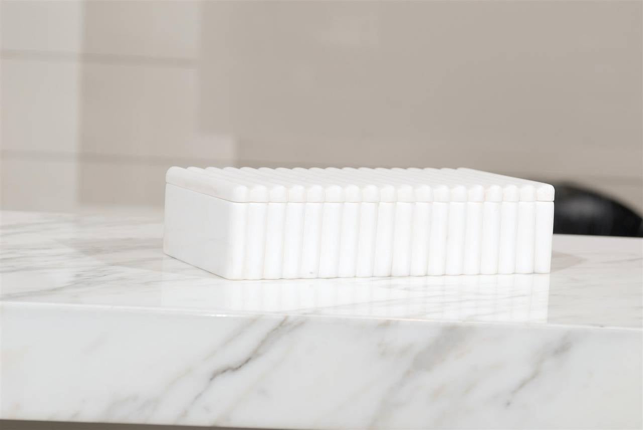 * Made from white Calcutta Marble 
* Unique ribbed detail around box 
* Use it to store personal belongings or as a decorative piece