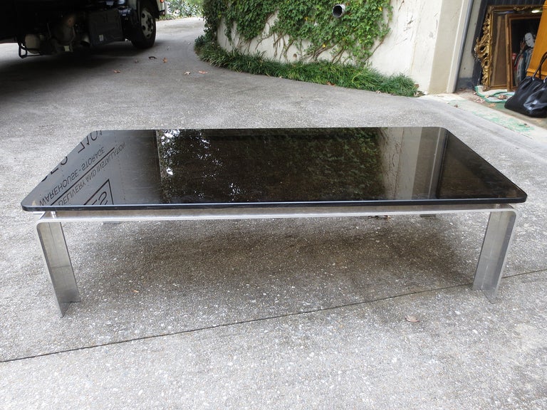 Mid-20th Century aluminum coffee table, in the style of Willy Rizzo. Black mirror glass top.