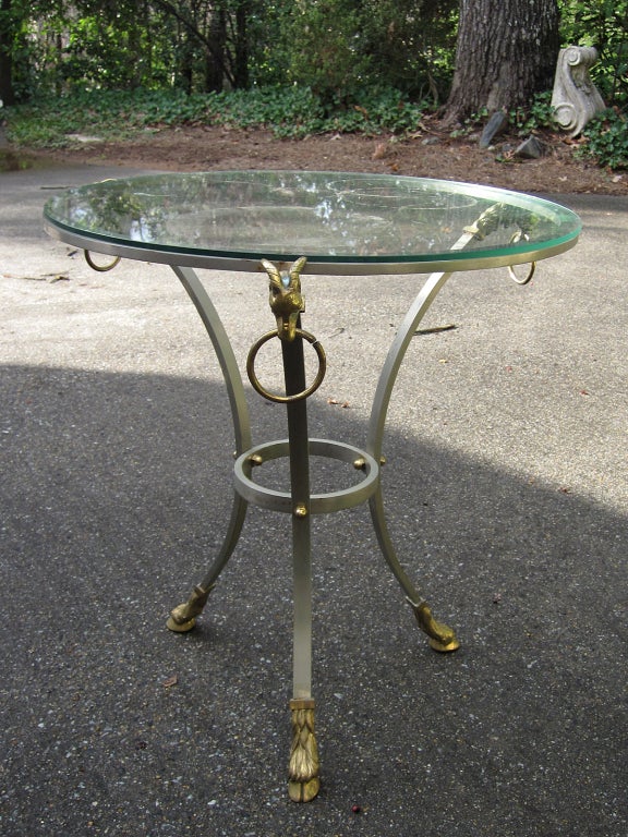 Mid-20th century steel and brass gueridon table with glass top
In the style of Maison Jansen.