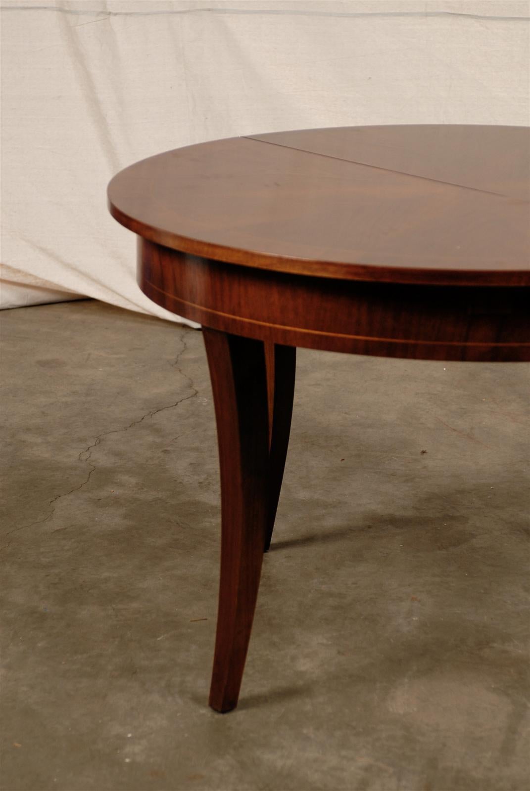 Late 19th/Early 20th Century Austrian Style Round Walnut Extension Dining Table with Starburst Top. 
Beautiful Patina, String Inlay. Very functional. Elegant and Simple Lines 
Made in Austria paper label