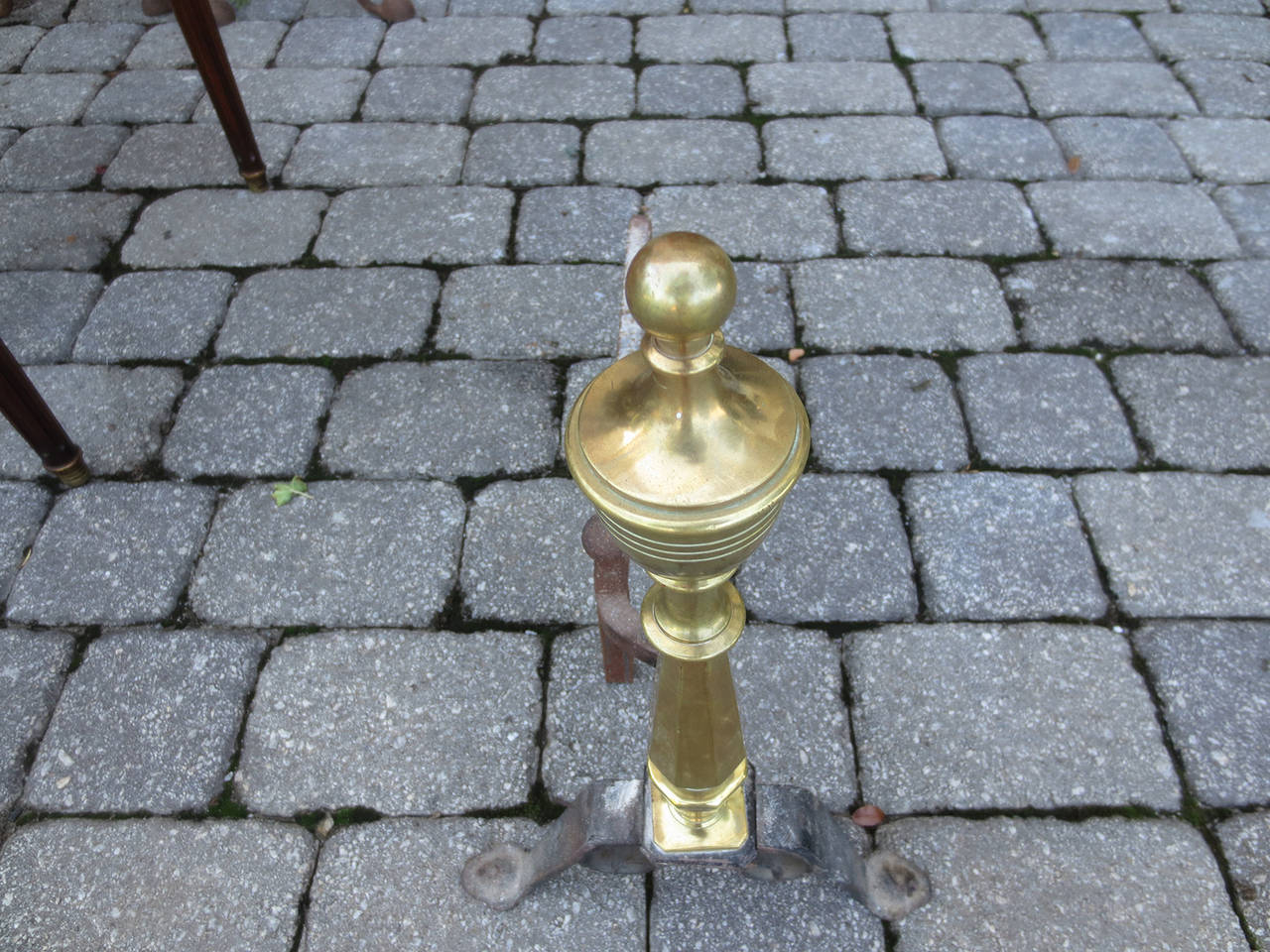 Late 19th century or early 20th century brass and iron andirons.