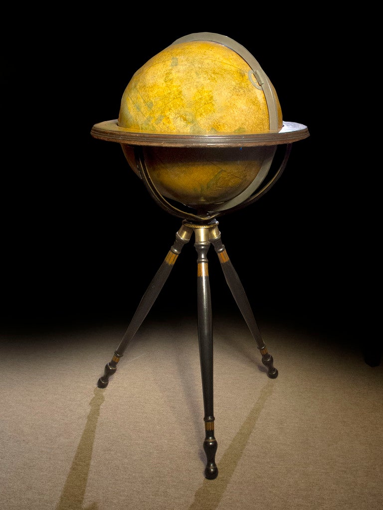 Terrestrial globe by Gilman Joslin (1804-circa 1886) of Boston. The terrestrial sphere, with the latest geographic findings, surrounded by a brass axis ring. The graceful ebonized tripod stand in the Etruscan style and enriched with polychrome and