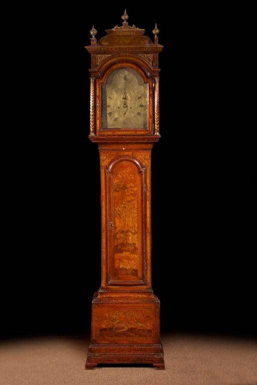 # V515 - Mid-18th century red lacquered long case clock by Robert Leumars, London. Note the decorative gold chinoiserie painting on a rich red ground. The well proportioned case with a caddy form hood surmounted by three finials over free standing