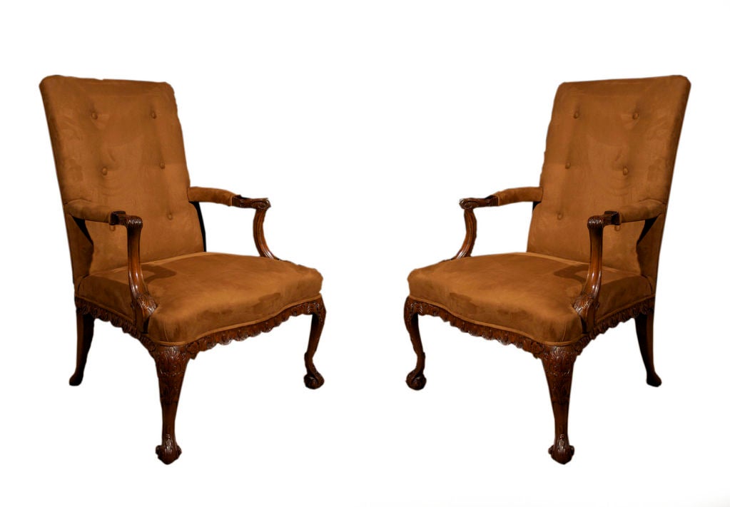 PAIR Georgian style mahogany Gainsborough armchairs of comfortable proportions and enriched with carved details.<br />
Note the carved and molded details on the upswept serpentine curved arms, apron and cabriole legs.<br />
All inspired by the