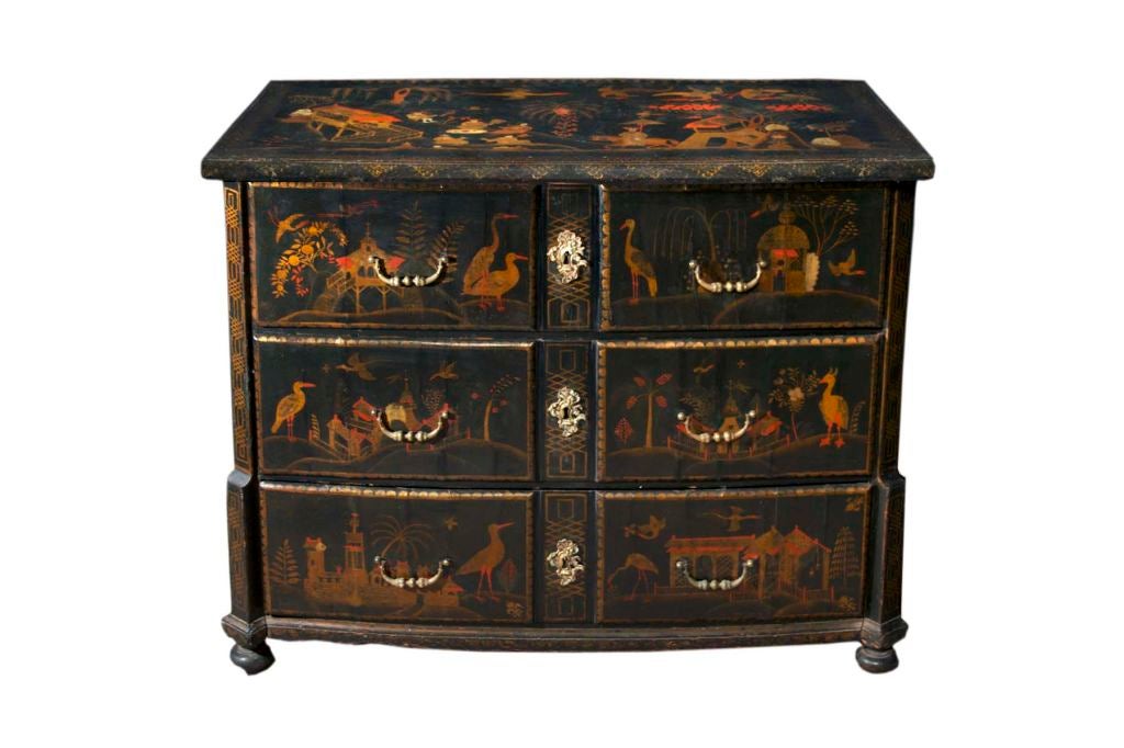 # W014 - Continental bowed fronted japanned chest of drawers  fitted with three drawers flanked by canted corners, supported by bun feet. All richly decorated with gold lacquer Chinoiserie motifs on a black ground.
The Dutch East India Company's