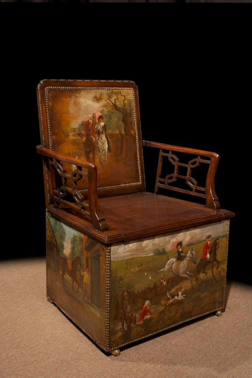 # V126 - Unusual George III mahogany arm chair with beautifully painted polychrome hunt scenes on leather panels on the backrest and lower sides all around. The lift seat (hiding the chamber pot) flanked by a pair of pierced arms of graceful