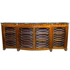 Regency Rosewood shaped Side Cabinet with brass inalys. English Circa 1815