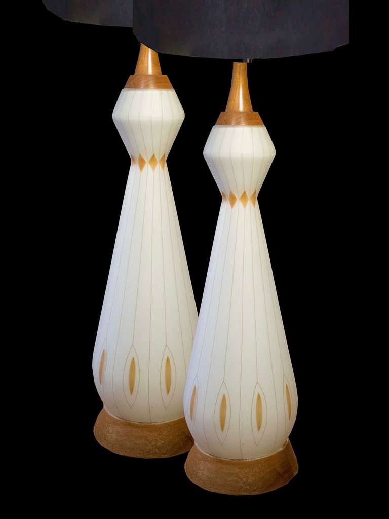 # A525 - PAIR vintage Danish Modern table lamps. The white glass elongated vase form decorated with lines suggesting fluting with turned walnut tops and bases.
Danish, Circa 1950

See similar examples on our website.  

Florian Papp, fine