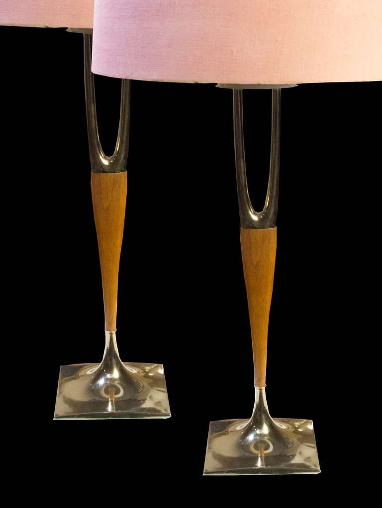 # A1000 - Pair of Gerald Thurston designed “Wishbone” lamps by Laurel Lamp Company. The round tapering solid walnut post surmounted by a stylized brass “Wishbone” motif and all resting on a square brass bases.
(shades not included).
American,