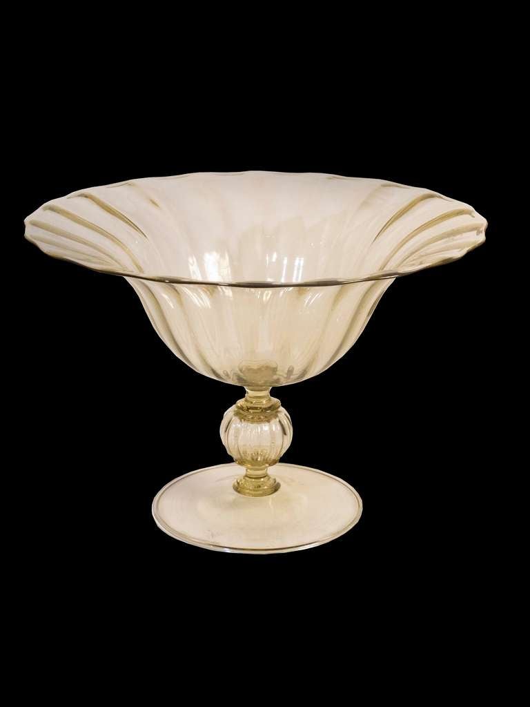 # A1028 - Vittorio Zecchini design for Venini factory blown glass tazza of graceful design enhanced by fluting following the form and all in a subtle amber.
Venetian glassmakers are recording working as early as 982, forming a guild by 1255 and in