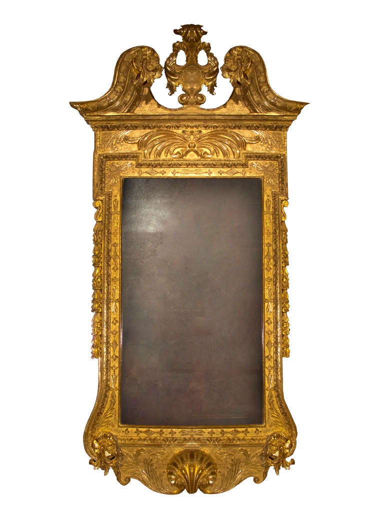 # Q514 - Important George II mirror in the manner of William Kent (architect and designer for Royalty in the first half of the 18th century). The rectangular mirror plate surrounded by carved and gilt wood surmounted by a swan neck architectural