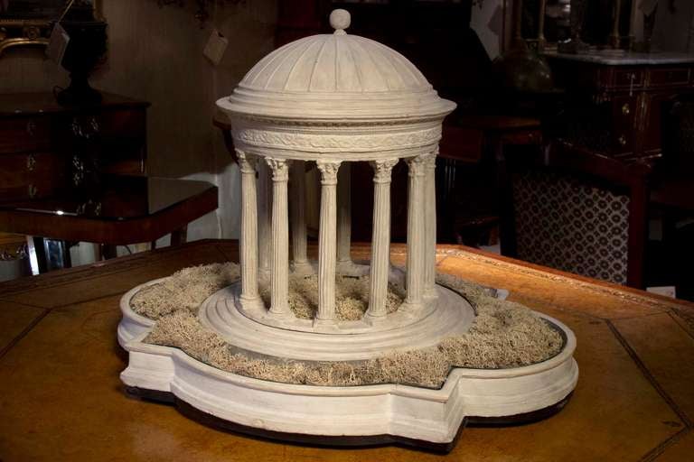 # Y025 - Neoclassical model of a garden folly centering a domed round columned temple surrounded by reservoirs to receive foliage or flowers. These were often used as dining table decoration.
English 19th C

See similar examples on our website
