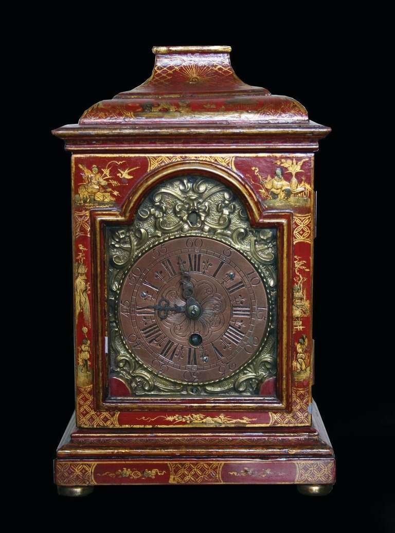 # T058 - Rare mid-Georgian red Japanned bracket clock with all-over chinoiserie decoration. The cushion shaped top above a shaped glass door with an engraved brass dial and raised on a plinth base and brass ball feet.
English, mid-18th
