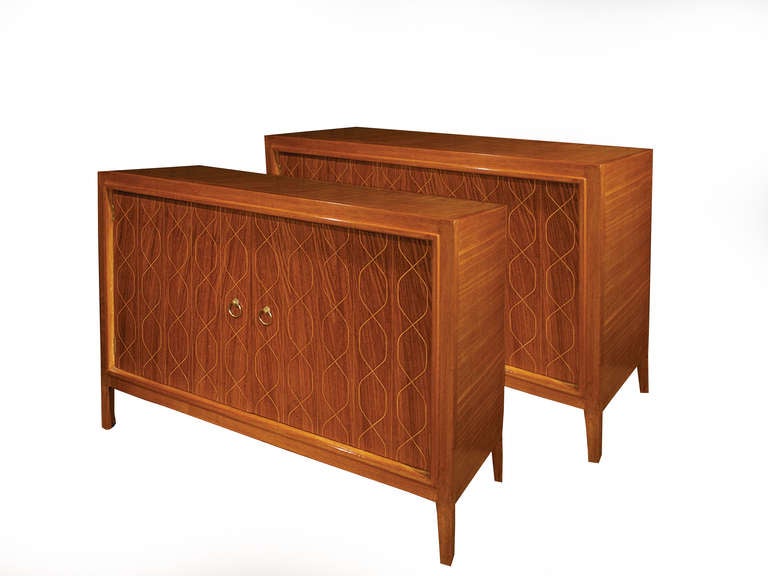 # A1051 - PAIR cabinets designed by Booth for the 1951 Festival of Britain.  Enclosed by a pair of rosewood veneered doors with interwoven vertical lines revealing an interior drawer and shelf balanced on short tapering legs.  A copper finish metal